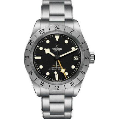 A front view of the Tudor Black Bay Pro watch on a stainless steel bracelet. It features a black dial with luminescent markers, a prominent yellow 24-hour hand, and a fixed stainless steel bezel with a 24-hour scale.